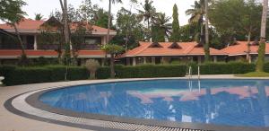 a large swimming pool in front of a house at TRAVANN in Alleppey
