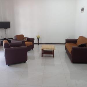 a living room with couches and a coffee table at Villa in Yakkala, Gampaha 