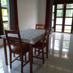 a dining room table with two chairs and a table and a table and chairsuggest at Villa in Yakkala, Gampaha 