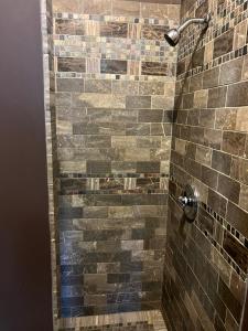 a bathroom with a shower with brown tiles at Soul Food in New York