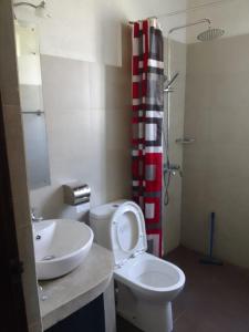 a bathroom with a toilet and a sink and a shower at Nothern Residence in Jaffna