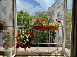 a balcony with a window with flowers on it at Feel Home DeLuxe CORVIN # FREE PARKING # AC # Elevator in Budapest