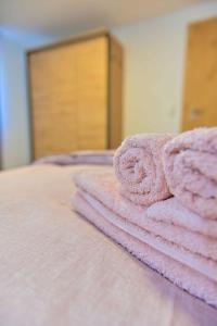 a pile of pink towels sitting on top of a bed at Haus Traumhorst in Heiligenblut