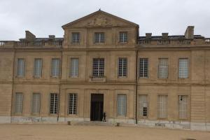 a man standing in the doorway of a large building at Maisonnette de Jardin in Marseille