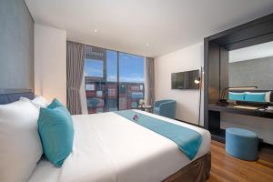 Łóżko lub łóżka w pokoju w obiekcie The Code Hotel & Spa Da Nang