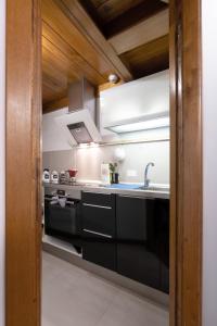 a kitchen with a sink and a stove at Maison Bilot in Rome