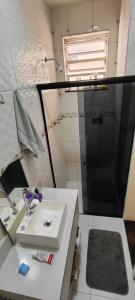 a bathroom with a sink and a shower at Apartamento bambu Laranjeiras in Rio de Janeiro