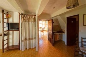 a living room with a curtain in a room at Chambres d'hotes - La Maison de Julie in Entrevaux