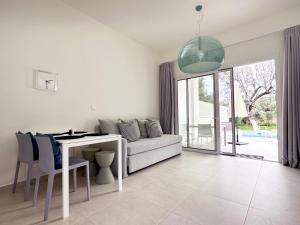 a living room with a couch and a table at Splash Suites with Private Pools in Nikiana