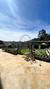a park with an arch in the middle of a field at Chill@hill in Ooty