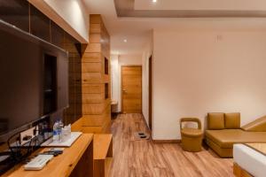a living room with a couch and a table at Hotel Central Plaza in Siliguri