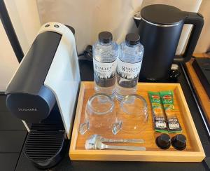 a table with a blender and two bottles of water at Naramountainkhaoyai 04 in Ban Tha Chang