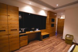 a large room with wooden cabinets and a kitchen at Hotel Central Plaza in Siliguri