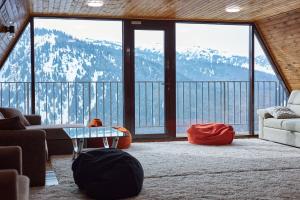 a living room with a view of a mountain at Karakol Resort in Karakol