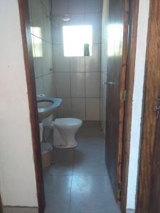 a bathroom with a toilet and a sink at Chácara Sol Nascente in Ibiúna +11 photos
