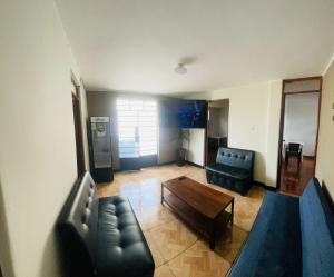 a living room with a couch and a coffee table at DEPARTAMENTO CON 3 DORMITORIOS in Huánuco