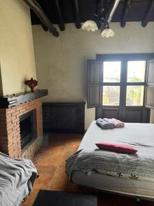 a bedroom with a bed and a fireplace at Apartamentos en Alfacar in Alfacar