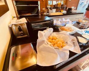 a kitchen with a counter with some food on it at Pousada Gardenian in São Roque