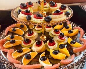 a cake with fruit and olives on top of it at Pousada Gardenian in São Roque