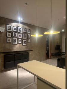 een keuken met een tafel en foto's aan de muur bij Soho Suites KLCC By Inam Suites in Kuala Lumpur