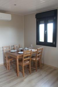 a dining room with a wooden table and chairs at le clos du popey in Saint-Romain-de-Popey +7 photos