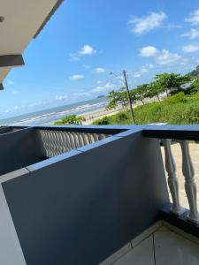 a balcony with a view of the beach at Pousada Costa do Sol in Peruíbe