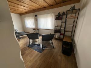a room with two chairs and a ladder in it at Vidiecky domček in Pohronská Polhora