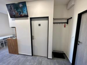 a room with a white door and a tv on the wall at Hotel Hangar in Mošnov