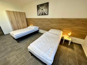 a room with two beds and a table with a lamp at Hotel Hangar in Mošnov