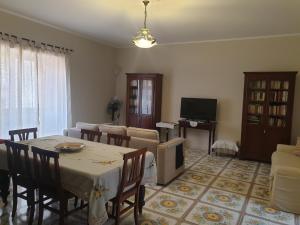 a living room with a table and a couch and a television at Residenza Sorrentina in Sorrento +23 photos