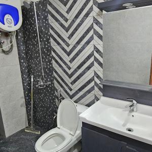 a bathroom with a toilet and a sink at 1 Bed Luxury Apartment in Lahore