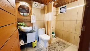a small bathroom with a toilet and a sink at Calm Shack - 2 Bedroom-Boutique Farm Stay in Munnar