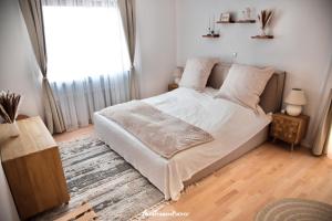 Wipfeld的住宿－Mainblick Apartment，一间卧室配有一张带白色床单的床和一扇窗户。