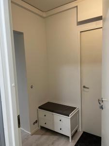 a room with a door and a dresser and a closet at Roomvantaa in Vantaa