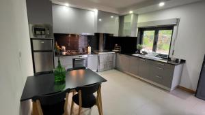 a large kitchen with a table and chairs in it at Quinta da Luena in Candemil