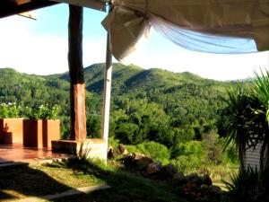 a view from the porch of a house with a mountain at El Calden in Villa Ciudad de America +19 photos
