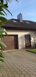 a brick house with a garage with a door at Ferienwohnung zwischen den Meeren 