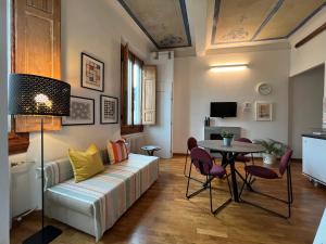 a living room with a couch and a table at Scala Apartments in Florence