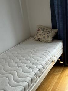 a bed in a room with a pillow on it at Beautiful apartment for you in Ulm