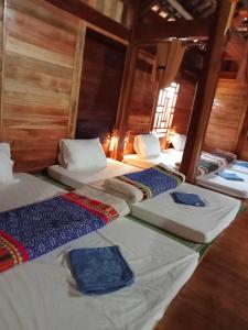 a group of four beds in a room at Homestay Mạnh Châu in An Pon