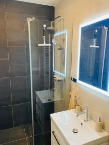 ein Bad mit einer Glasdusche und einem Waschbecken in der Unterkunft Luxusný apartmán v centre in Banská Bystrica