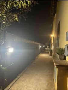 un callejón vacío por la noche con luces en la pared en Casa vacanze Manzoni 289 en Perugia