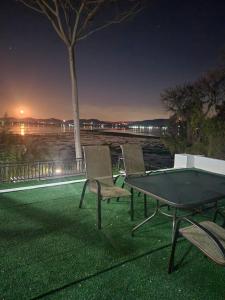 two chairs and a ping pong table at night at Le Bamboo Guest House And Boat Cruise in Hartbeespoort