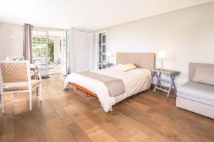a bedroom with a bed and a chair and a table at Golfetmer in Saint-Jean-de-Luz
