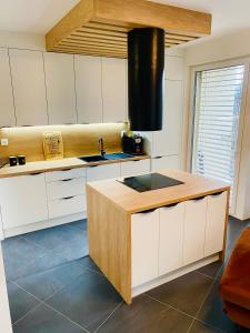 a kitchen with white cabinets and a counter with a sink at Luxusný apartmán v centre in Banská Bystrica