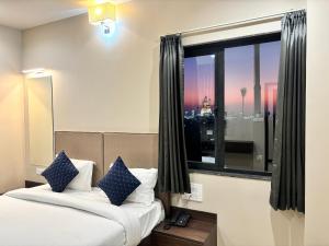 a hotel room with a bed and a window at Maruti Group of Hotels - The Shivam in Nāthdwāra +37 photos