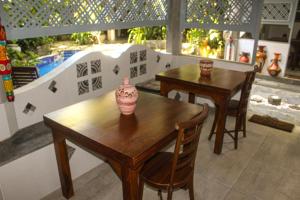 a table and chairs with a vase on top of it at Villa Olde Ceylon in Kandy
