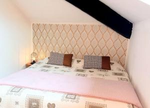 a bedroom with a bed with two pillows on it at Mansarda in centro Menaggio con spiaggia privata e possibilità garage in Menaggio
