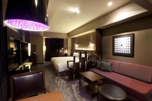 a hotel room with a bed and a couch at The Royal Park Hotel Iconic Tokyo Shiodome in Tokyo