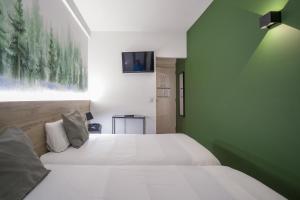 Voodi või voodid majutusasutuse Glaner Hotel Cafe toas
